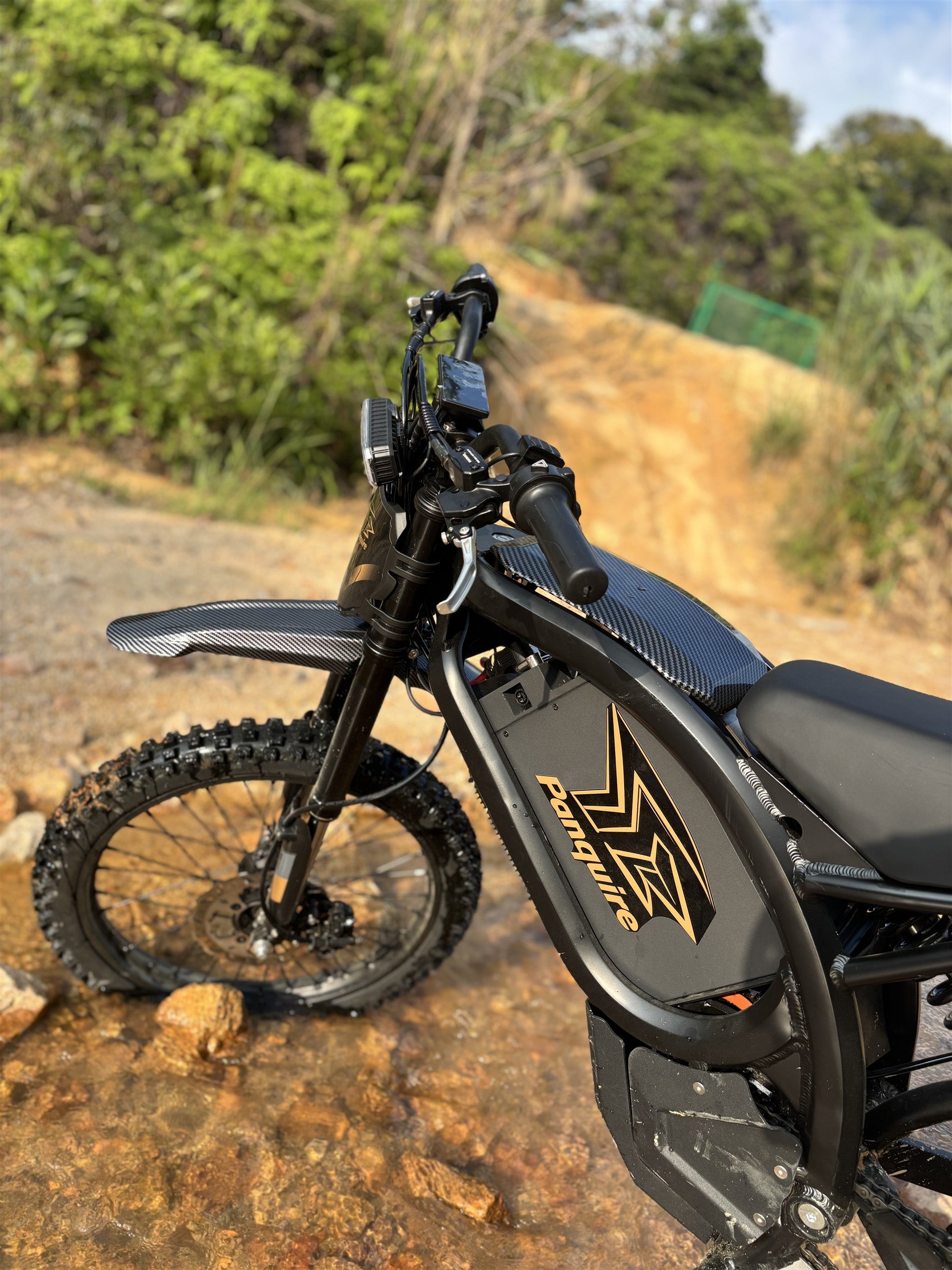 Panquire electric motorcycle on a forest trail